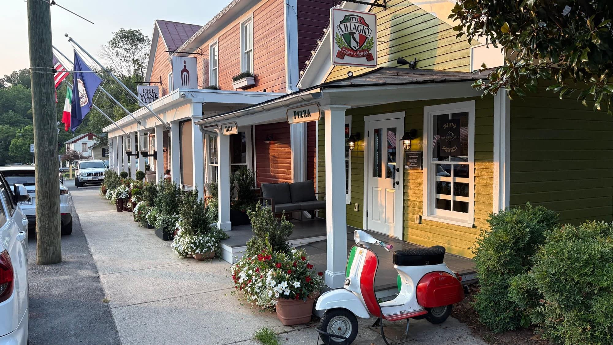 Storefronts along Clifton's Main Street, including The Wine Attic and Little Villagio