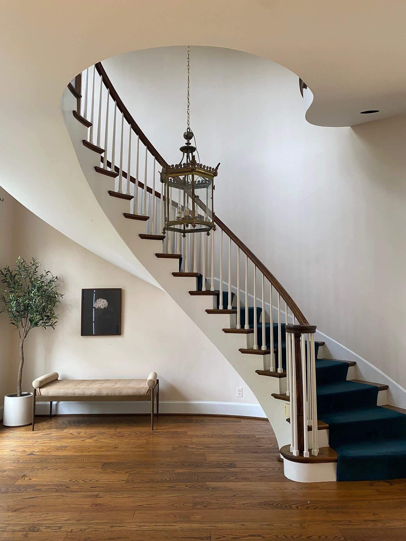 A grand, elegantly staged curved staircase in a well-prepared Northern Virginia home